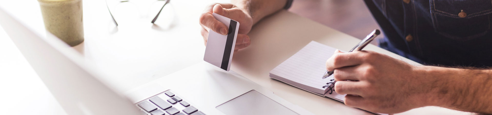 Man using a credit or debit card on a laptop computer